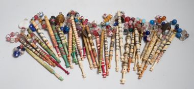 Twenty one 19th century stained and turned bone lace bobbins with glass bead tops and thirteen