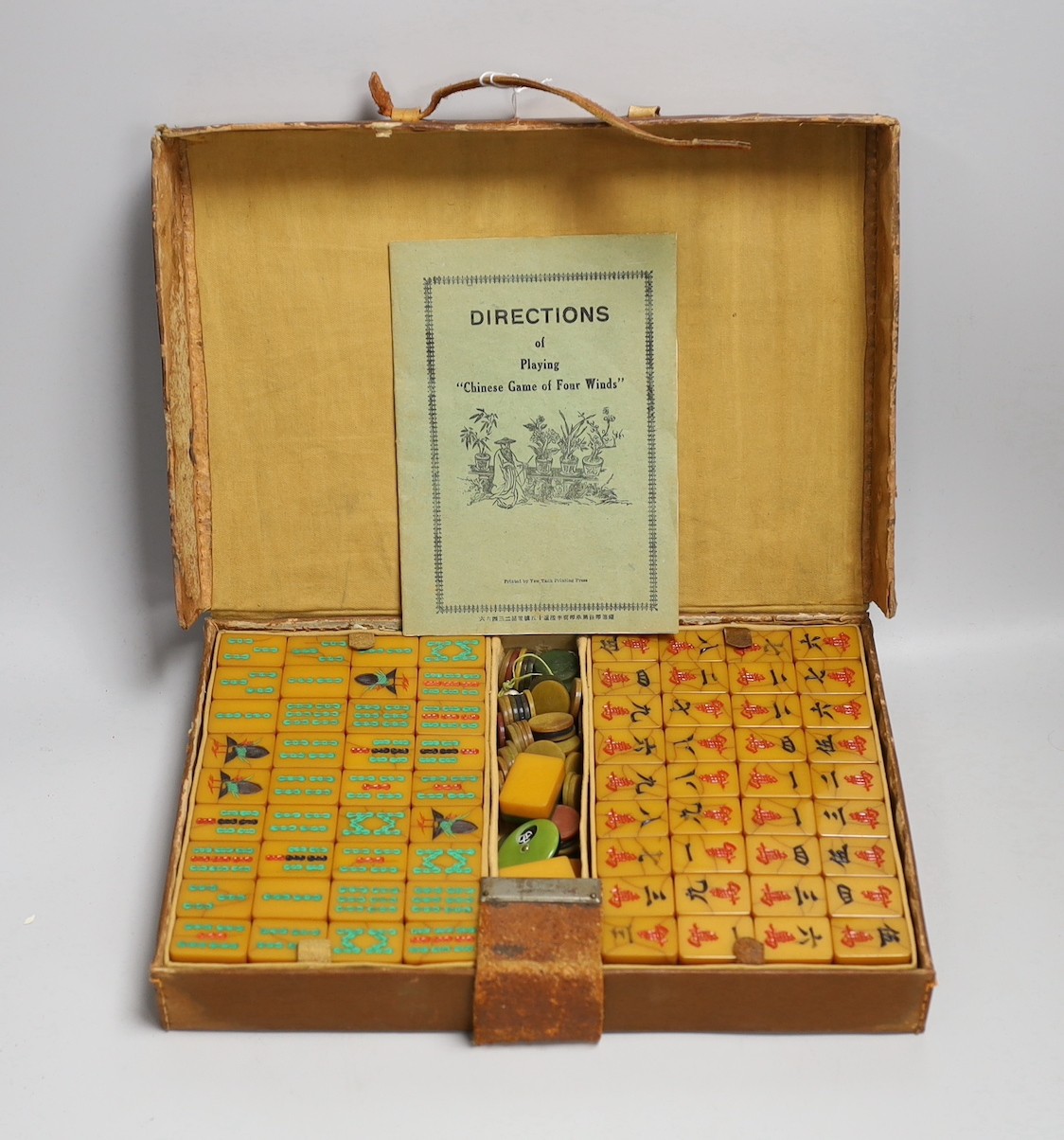 A leather cased Bakelite mahjong set