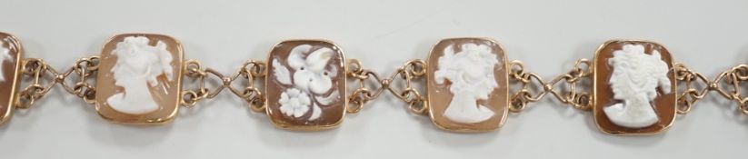 A 1970's 9ct gold and seven cameo panel set bracelet, carved with busts of ladies or flowers,