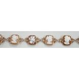 A 1970's 9ct gold and seven cameo panel set bracelet, carved with busts of ladies or flowers,