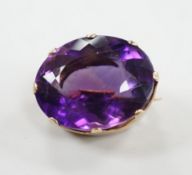 A modern 9ct gold mounted oval facet cut amethyst brooch, 22mm, gross weight 8.5 grams.