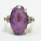 A yellow metal and oval cut amethyst set dress ring, with six stone diamond set shoulders, size O,