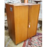 A mid century teak 'Magic Box' enclosed desk, width 82cm, depth 54cm, height 115cm