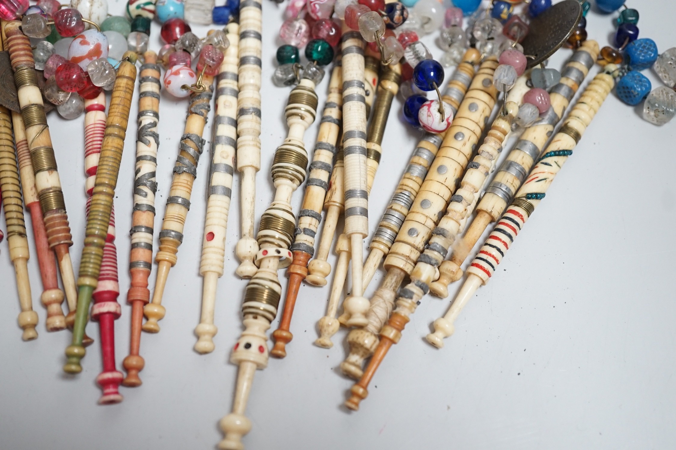 Twenty one 19th century stained and turned bone lace bobbins with glass bead tops and thirteen - Image 3 of 8