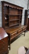 An 18th century style oak dresser with boarded rack, width 178cm, depth 51cm, height 200cm