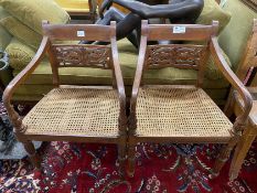 A pair of Indonesian caned hardwood elbow chairs, width 55cm, depth 44cm, height 86cm