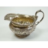 A late Victorian embossed squat silver cream jug, Edward Barnard & Sons, London, 1898, height