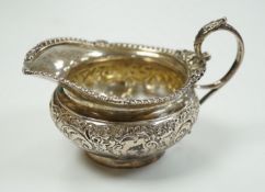 A late Victorian embossed squat silver cream jug, Edward Barnard & Sons, London, 1898, height