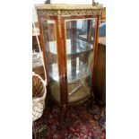A Louis XV style gilt metal mounted marble topped bow fronted vitrine, width 67cm, depth 34cm,
