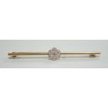 An 18ct and seven stone diamond set flower head cluster bar brooch, 57mm, gross weight 4.7 grams.