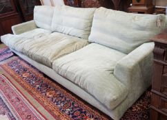 A large Howard style three seater settee upholstered in pale green fabric, length 300cm, depth