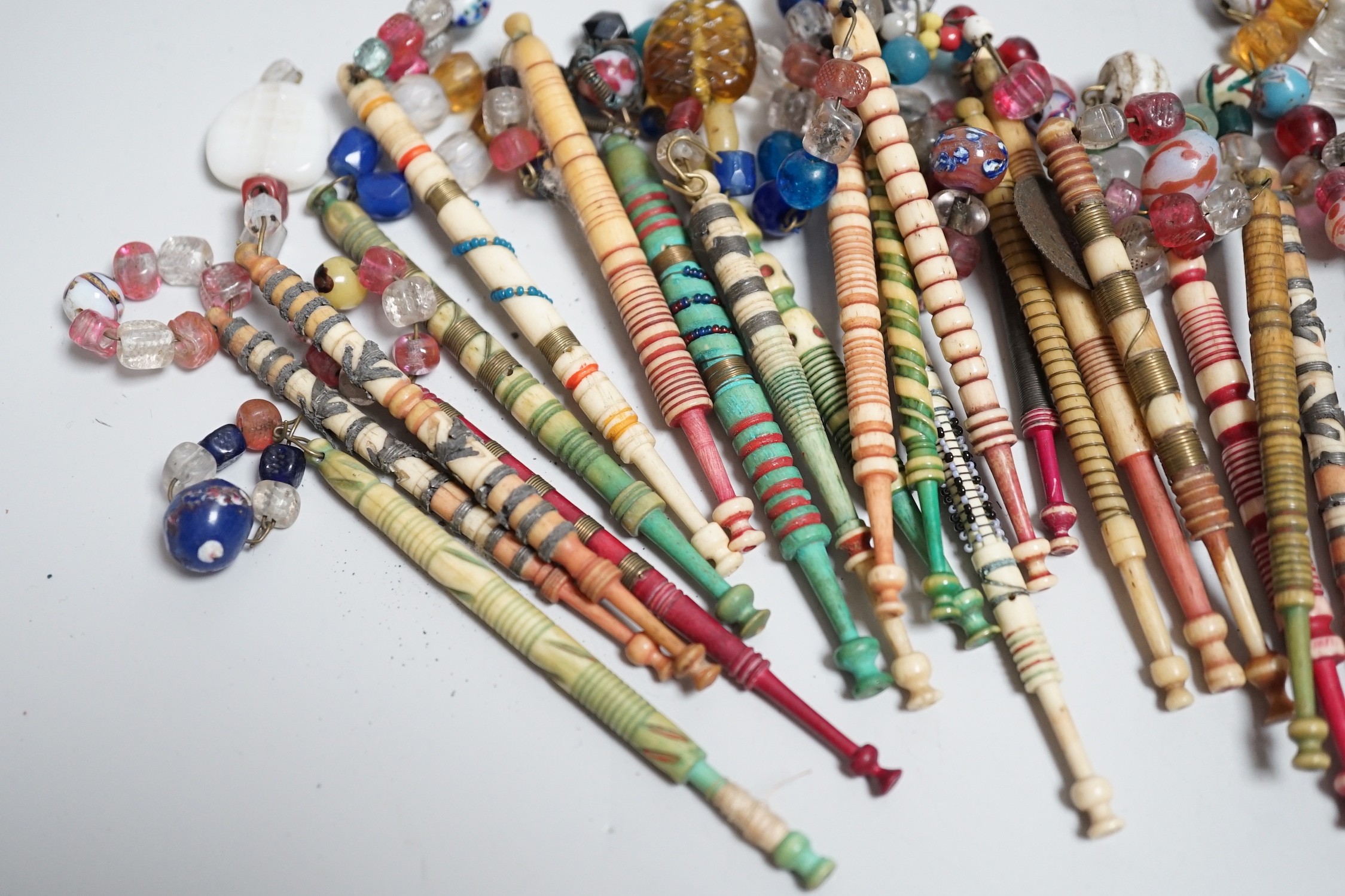 Twenty one 19th century stained and turned bone lace bobbins with glass bead tops and thirteen - Image 8 of 8