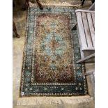 A North West Persian green ground rug, 150 x 90cm