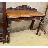 A Victorian oak console table, vacant shield cartouche and scrolling acanthus surmount to back,