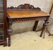 A Victorian oak console table, vacant shield cartouche and scrolling acanthus surmount to back,