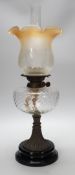 A Victorian brass stemmed oil lamp and glass shade, 50cms including shade