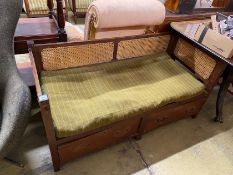 A provincial rustic oak bergère caned two drawer low bench seat, length 136cm, depth 61cm, height