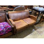 A mid century style tan leather two seater settee, length 144cm, depth 80cm, height 82cm