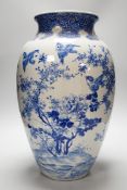 A large Japanese blue and white vase decorated with foliage and birds, 49cms high