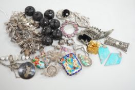 A silver charm bracelet hung with fifty assorted charms and a group of assorted jewellery