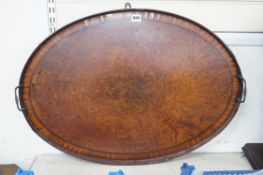 A burr walnut oval, two handled tray, 72cms wide