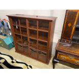 An early 20th century pine sliding door cabinet, width 129cm, depth 38cm, height 125cm