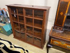 An early 20th century pine sliding door cabinet, width 129cm, depth 38cm, height 125cm