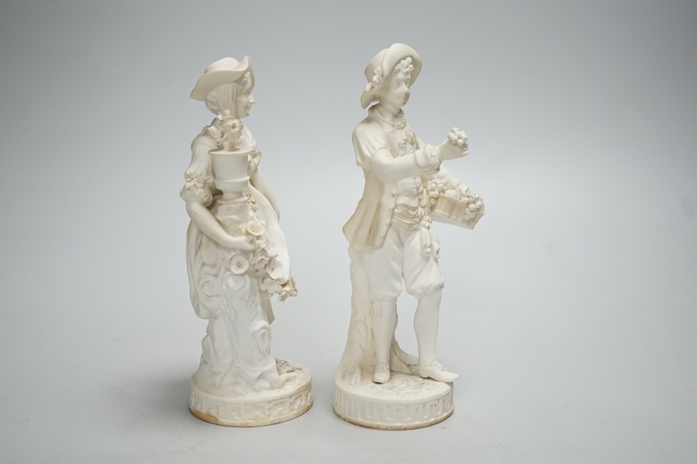 A pair of Minton biscuit figures of a boy and girl with flowers, on circular bases, 19cm - Image 4 of 5