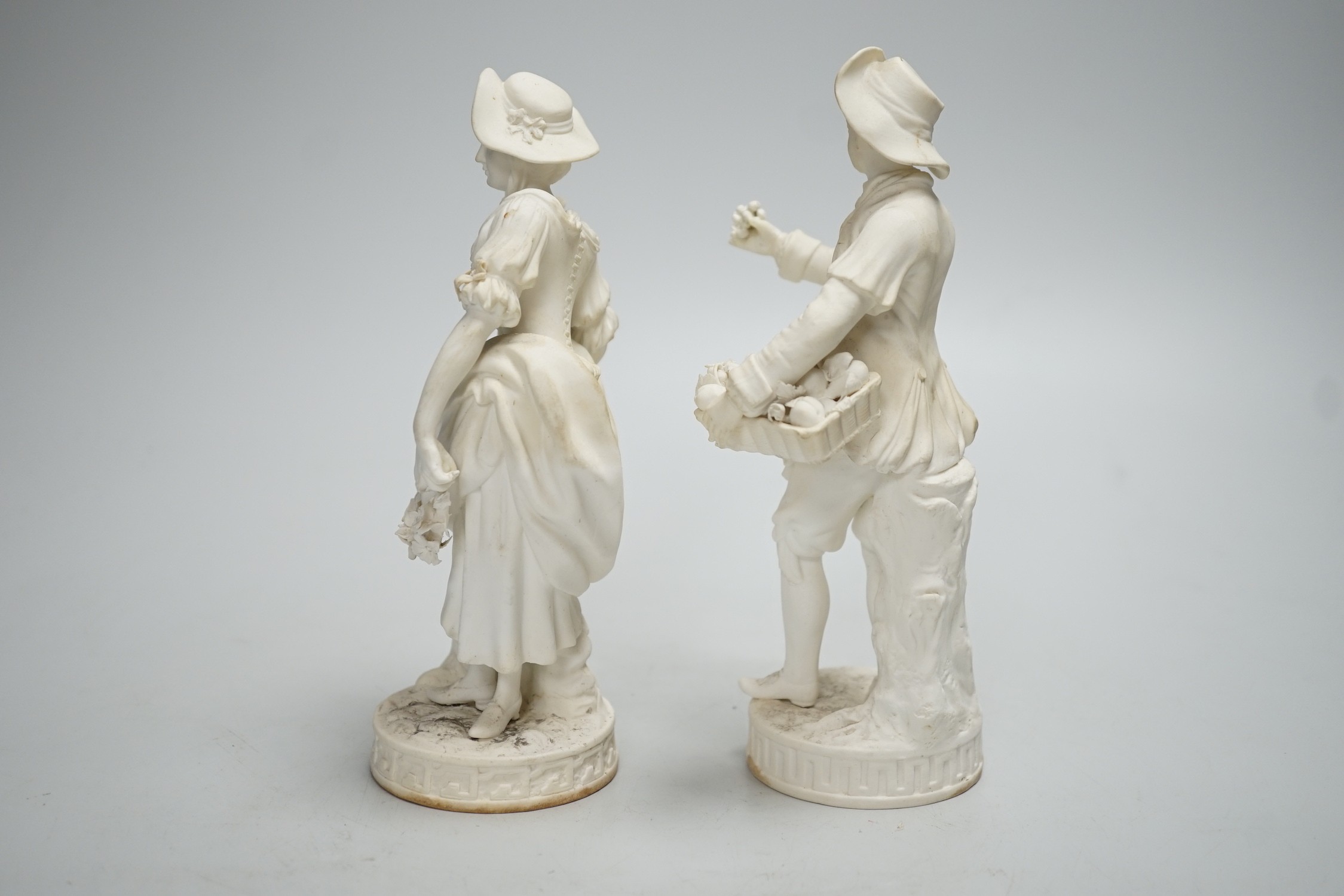 A pair of Minton biscuit figures of a boy and girl with flowers, on circular bases, 19cm - Image 2 of 5