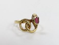 An early 20th century yellow metal and single stone garnet set entwined serpent ring, with diamond