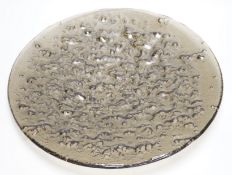 A large rubber-based pewter-coloured glass dish, 48cm