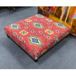 A large square contemporary footstool upholstered in red ground Kilim style fabric, width 102cm,