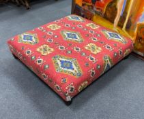 A large square contemporary footstool upholstered in red ground Kilim style fabric, width 102cm,