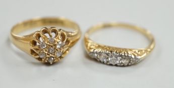 Two early 20th century 18ct and diamond cluster set rings, including graduated five stone, sizes