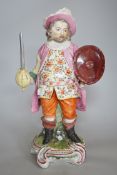 A large Derby figure of Falstaff standing, holding a sword and shield, patch marks, original brass