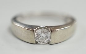 A modern 9ct white gold and solitaire diamond set ring, the stone weighing 0.34ct, size M/N, gross