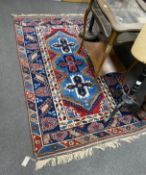 A Caucasian blue ground rug, 200cm x 118cm