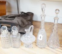 A pair of square cut glass decanters, two other decanters, all with stoppers and a similar jug,