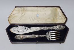 A cased pair of ornate Victorian silver fish servers, Martin, Hall & Co, Sheffield, 1856, knife 35.