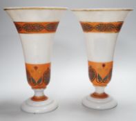 A pair of opaque glass anthemion vases, with orange decorative bands, 30cms high