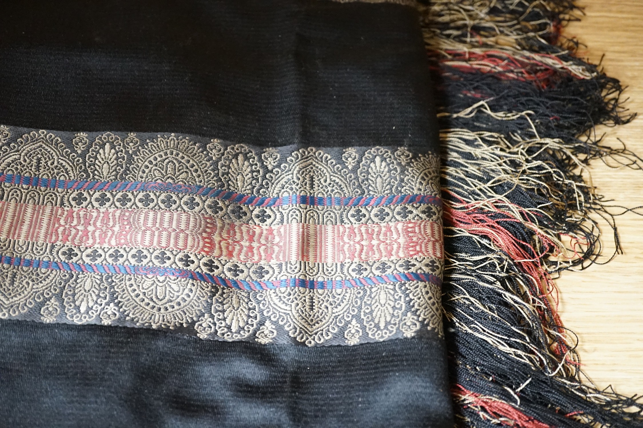 A Victorian black silk shawl woven, woven with multi-coloured Paisley designed stripes bordered with - Image 4 of 4