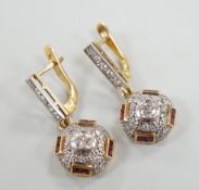 A modern pair of yellow metal, square cut ruby and round cut diamond set circular cluster drop