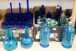 A collection of dark blue, green and turquoise coloured glassware, including three long stemmed