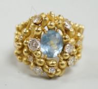 An early 1970's modernist 18ct gold, aquamarine and diamond cluster set dress ring, maker HB or