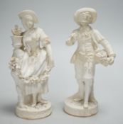 A pair of Minton biscuit figures of a boy and girl with flowers, on circular bases, 19cm
