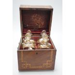 A George III inlaid mahogany decanter set with four gilt decorated decanters and two T.Goode & Co.