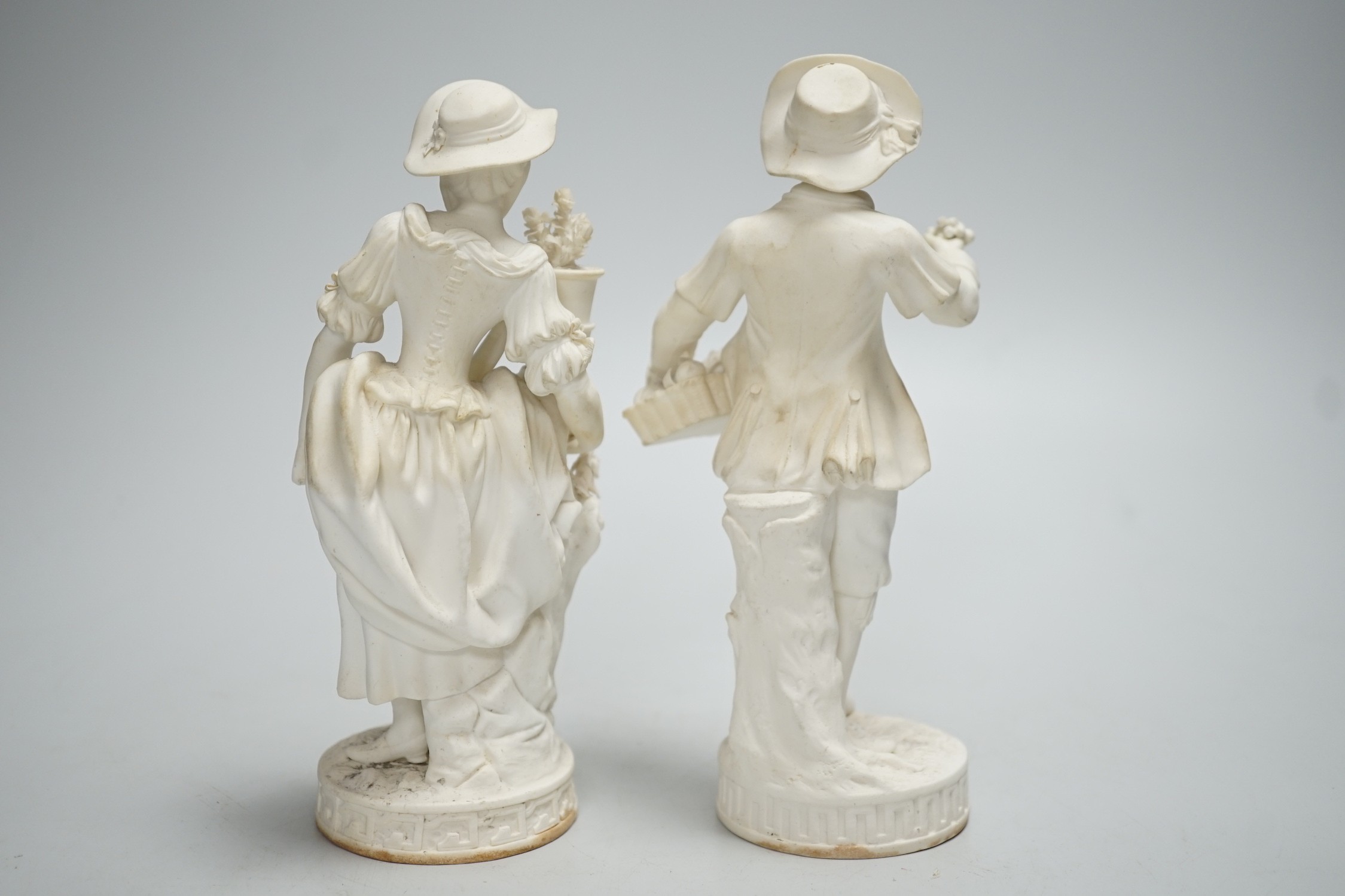 A pair of Minton biscuit figures of a boy and girl with flowers, on circular bases, 19cm - Image 3 of 5