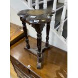 An unusual carved oak trefoil occasional table, width 36cm, height 58cm