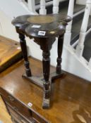 An unusual carved oak trefoil occasional table, width 36cm, height 58cm