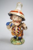 A Derby Mansion House Dwarf holding a walking stick, his hat with advertising, incised 227, c.1790-